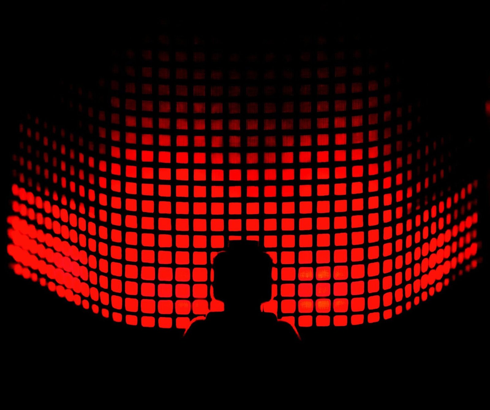 a person standing in front of a red light